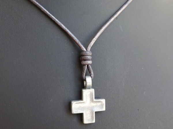 silver cross necklace on distressed gray leather 6
