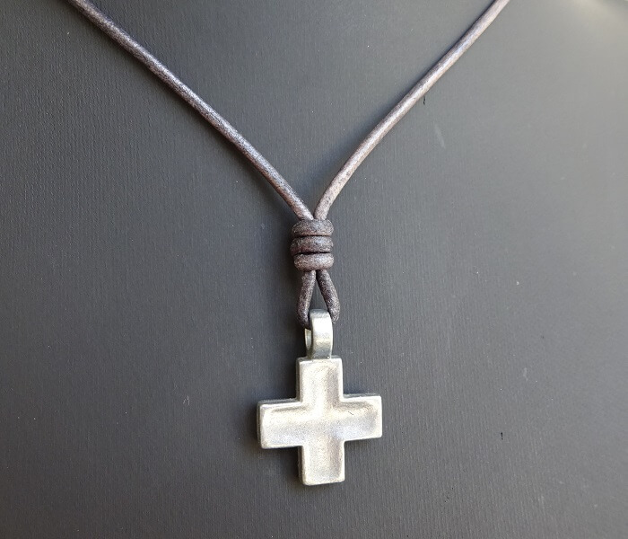 silver cross necklace on distressed gray leather 6