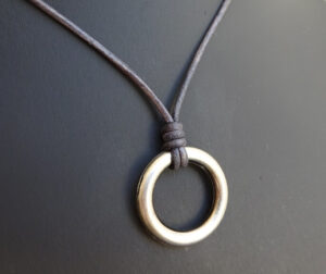 ring necklace on gray leather website