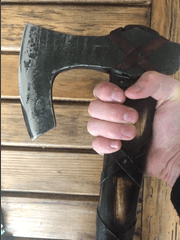 bearded viking axe hand behind blade
