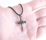 bronze nail cross necklace on hand
