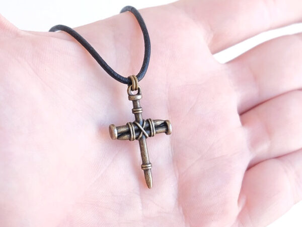bronze nail cross necklace on hand