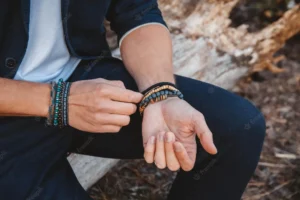 man wearing bracelet on both hands